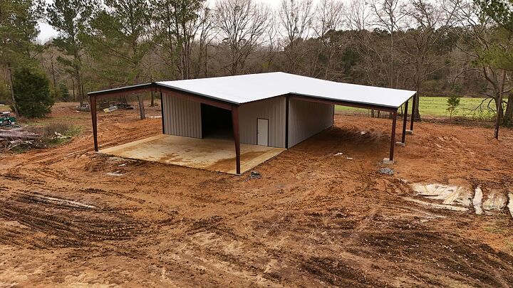 Aerial view of a tan metal building with lean-tos on three sides