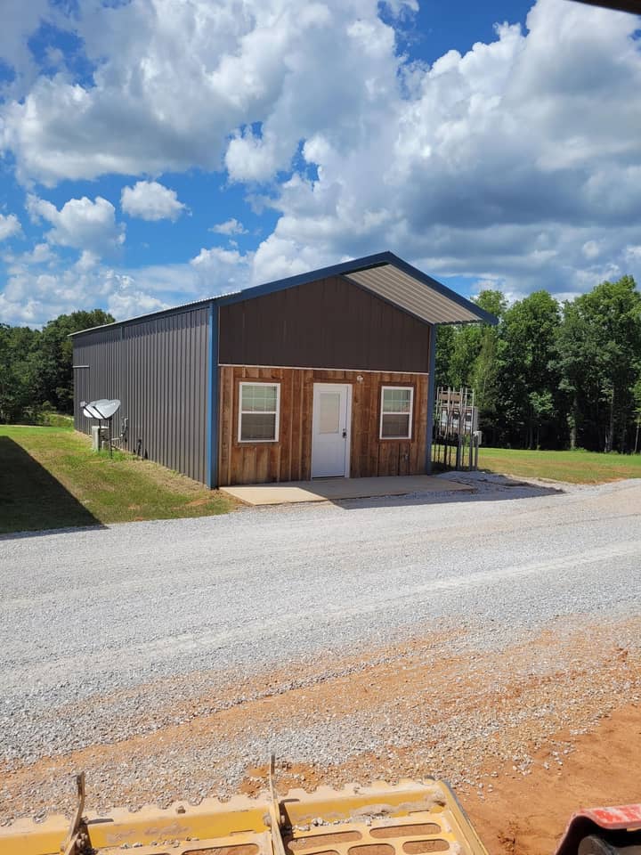 Metal cabin with wood front and gray steel sides