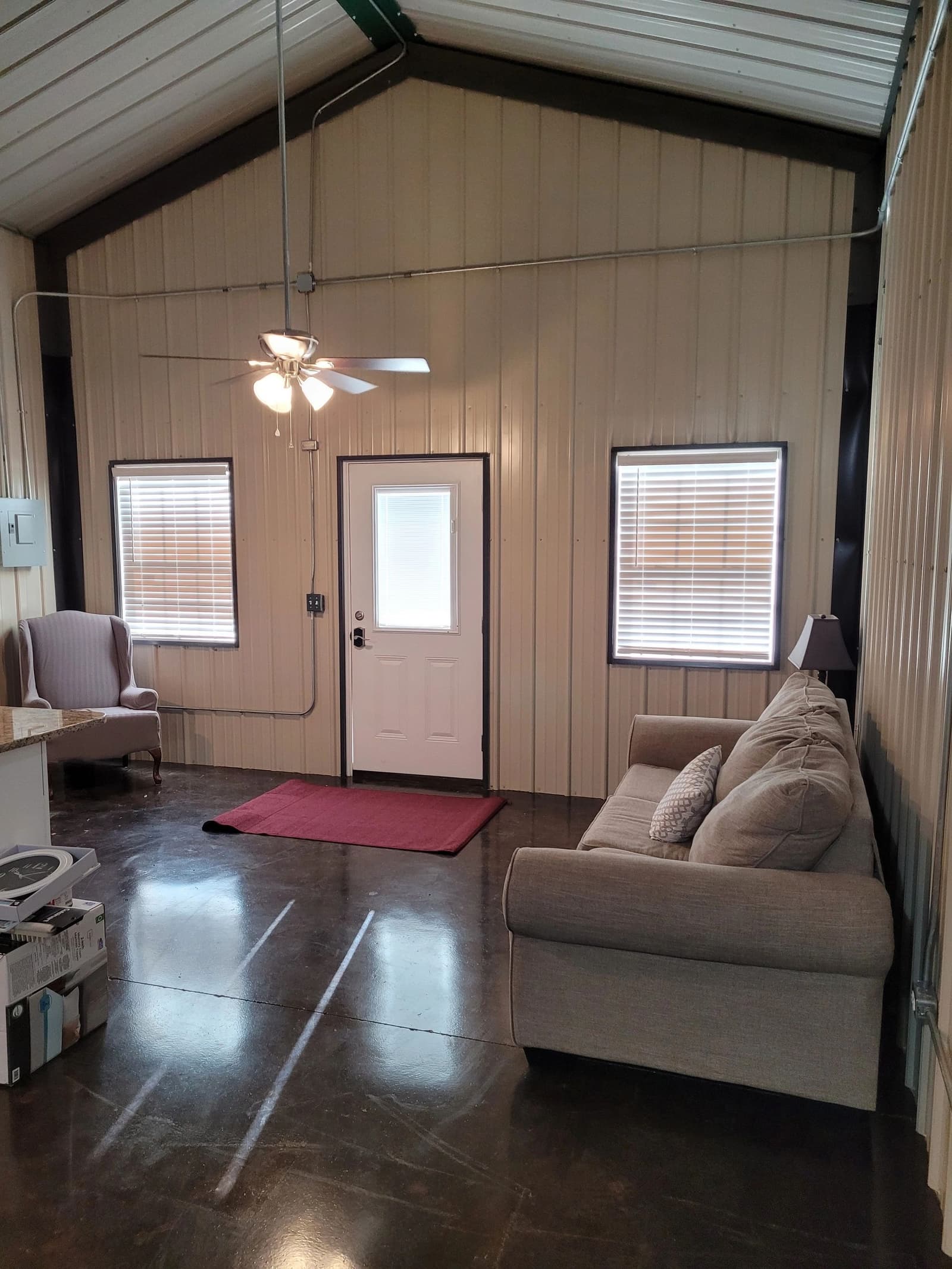Finished living room with stained concrete floors inside a metal home