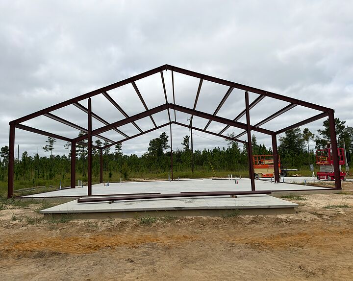 Red iron frame standing on a finished concrete slab