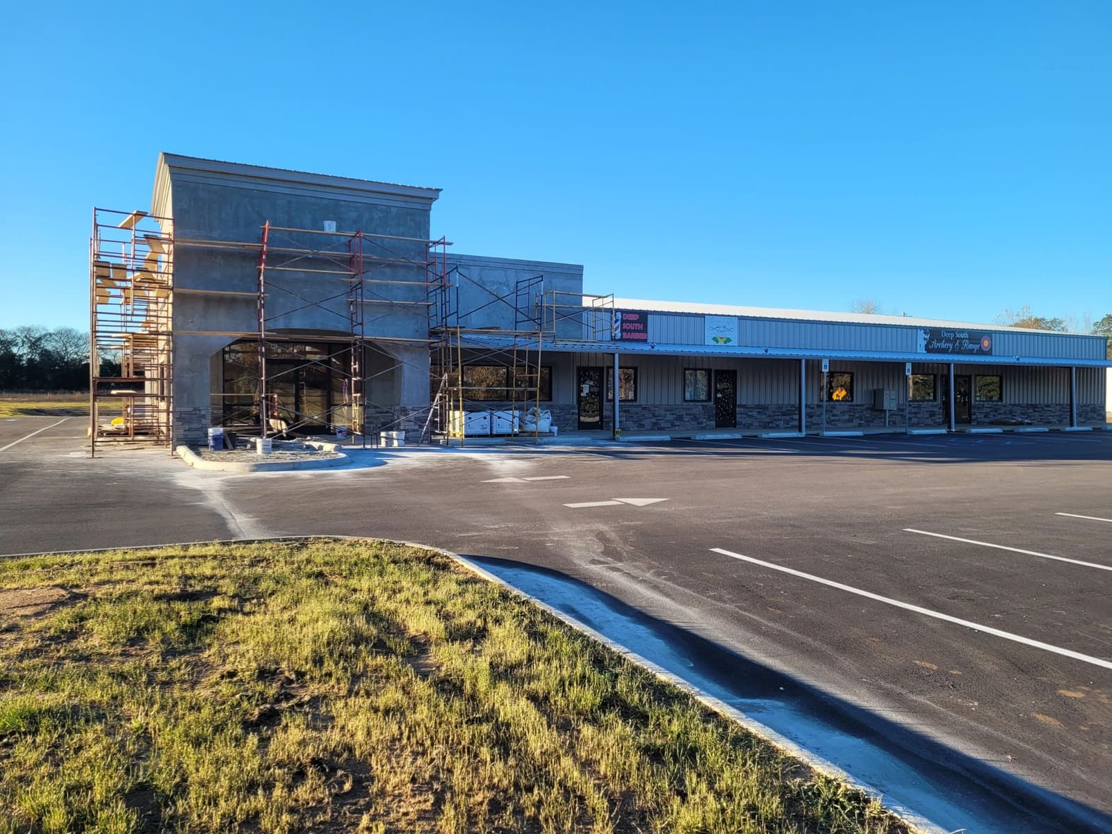Retail strip center under construction with scaffolding