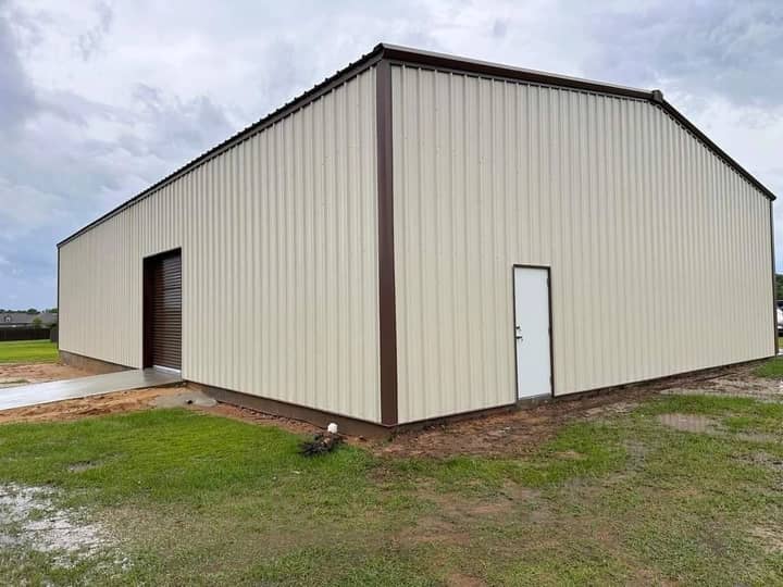Tan metal garage with brown trim and walk door