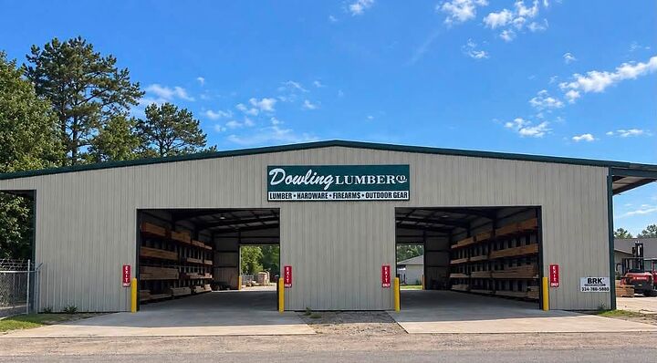 Tan metal lumber and hardware store with two drive-through bays