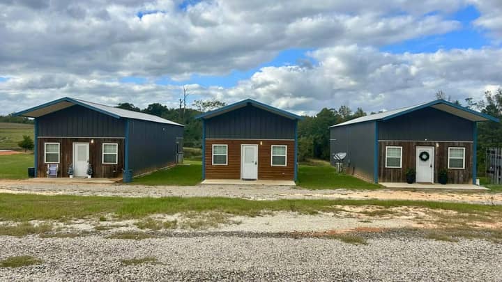 Three metal cabins with wood accent walls and front porches