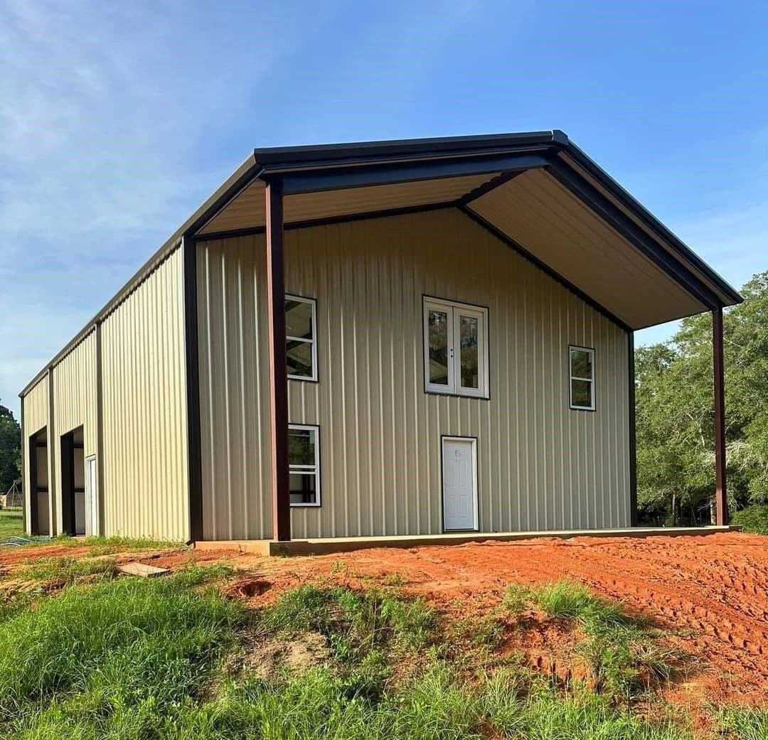 Two-story metal barndominium with wraparound porch