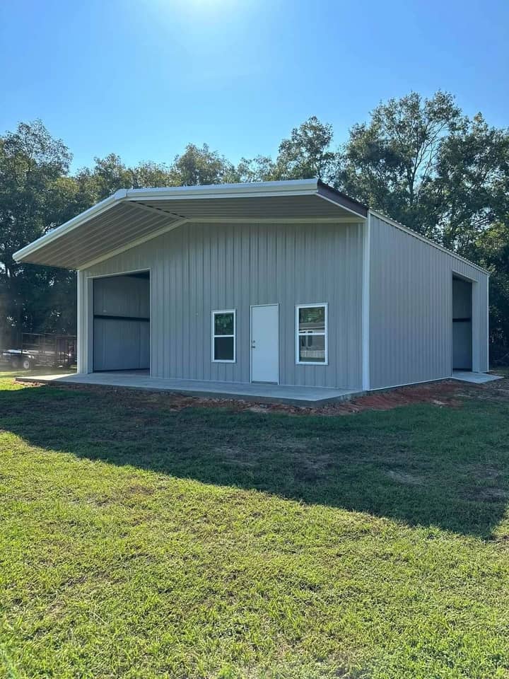 White metal garage building with side entry door